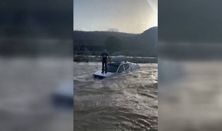 Debisi yükselen derede mahsur kaldı; aracının üzerine çıkıp yardım bekledi